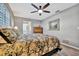 Main bedroom with ceiling fan, wood-look floors and ensuite access at 13923 Wildwood Dr, Largo, FL 33774