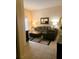 View of living room from entryway, showing sectional sofa and ottoman at 701 S Madison Ave # 106, Clearwater, FL 33756