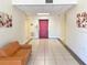 Building lobby with tiled floor, seating area, and elevator access at 701 S Madison Ave # 106, Clearwater, FL 33756