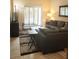 Living Room with sectional sofa, ottoman, and flat screen TV at 701 S Madison Ave # 106, Clearwater, FL 33756