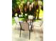 Small patio with table and four chairs, surrounded by palm trees at 701 S Madison Ave # 106, Clearwater, FL 33756