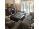 Living Room with sectional sofa, ottoman, and flat screen TV at 701 S Madison Ave # 106, Clearwater, FL 33756