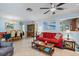 Spacious living room with red sofa and open floor plan at 301 Windrush Loop, Tarpon Springs, FL 34689