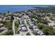 Aerial view showcasing a community of homes near the water at 301 Windrush Loop, Tarpon Springs, FL 34689