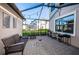 Screened patio with brick pavers, string lights, and garden at 12610 Rangeland Blvd, Odessa, FL 33556
