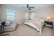 Spacious bedroom with king-size bed, ceiling fan and ample natural light at 12610 Rangeland Blvd, Odessa, FL 33556