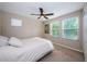 Bedroom with queen bed, ceiling fan, and large windows at 12610 Rangeland Blvd, Odessa, FL 33556