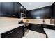 Modern kitchen with stainless steel appliances and dark cabinetry at 12610 Rangeland Blvd, Odessa, FL 33556