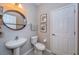 Clean and modern half bathroom with pedestal sink and updated fixtures at 12610 Rangeland Blvd, Odessa, FL 33556