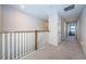 Upstairs hallway with carpeted floors and access to bedrooms at 12610 Rangeland Blvd, Odessa, FL 33556