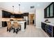 Modern kitchen with dark cabinetry, stainless steel appliances, and island at 12610 Rangeland Blvd, Odessa, FL 33556