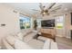 Relaxing living room with sectional sofa and a large flat-screen TV at 12610 Rangeland Blvd, Odessa, FL 33556