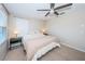 Bright bedroom with king-size bed, ceiling fan and large window at 12610 Rangeland Blvd, Odessa, FL 33556