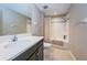 Full bathroom with tub shower combo, vanity and neutral tile at 12610 Rangeland Blvd, Odessa, FL 33556