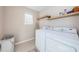 Laundry room with washer, dryer, and shelving at 12610 Rangeland Blvd, Odessa, FL 33556