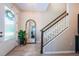 Bright and airy entryway with stylish mirror and staircase at 12610 Rangeland Blvd, Odessa, FL 33556