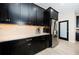 Modern kitchen with stainless steel appliances and dark cabinetry at 12610 Rangeland Blvd, Odessa, FL 33556