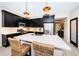 Gourmet kitchen featuring dark cabinetry, stainless steel appliances and an island at 12610 Rangeland Blvd, Odessa, FL 33556