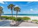 Beachfront patio with lounge chairs and ocean view at 19106 Gulf Blvd # 102, Indian Shores, FL 33785