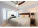 Bedroom with a queen bed, ceiling fan, and window seat at 19106 Gulf Blvd # 102, Indian Shores, FL 33785