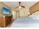 King bed, dresser, and TV in a beachy bedroom at 19106 Gulf Blvd # 102, Indian Shores, FL 33785