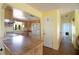 Hallway connecting kitchen to other rooms with light walls and wood floors at 904 Bayshore Dr, Terra Ceia, FL 34250