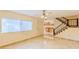 Spacious living room with tile floors and kitchen views at 707 1St Ct, Palm Harbor, FL 34684