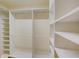 Large walk-in closet with shelves and hanging rods at 707 1St Ct, Palm Harbor, FL 34684