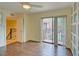 Bedroom with wood floors and access to balcony at 707 1St Ct, Palm Harbor, FL 34684