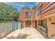 Townhouse patio with red door, planter boxes, and a tiled floor at 707 1St Ct, Palm Harbor, FL 34684