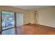 Bright bedroom with wood floors and sliding door to balcony at 707 1St Ct, Palm Harbor, FL 34684