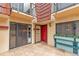 Townhouse patio with red door, sliding glass doors, and planter boxes at 707 1St Ct, Palm Harbor, FL 34684