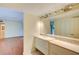 Bathroom with double vanity and access to bedroom at 707 1St Ct, Palm Harbor, FL 34684