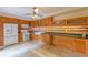 Open kitchen boasts wood cabinets, granite counters, and modern appliances at 707 1St Ct, Palm Harbor, FL 34684