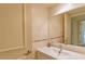 Simple bathroom with white vanity and large mirror at 707 1St Ct, Palm Harbor, FL 34684