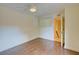Spacious bedroom with wood floors and access to stairs at 707 1St Ct, Palm Harbor, FL 34684