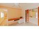 Home office with wood desk, built-in shelves, and view of kitchen at 707 1St Ct, Palm Harbor, FL 34684