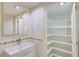 Bathroom with vanity, shelves and linen closet at 707 1St Ct, Palm Harbor, FL 34684