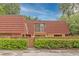 Exterior view of condo with red tile roof and wooden fence at 707 1St Ct, Palm Harbor, FL 34684