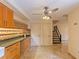 Kitchen features wood cabinets, granite counters, and a view to the stairs at 707 1St Ct, Palm Harbor, FL 34684