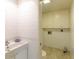 Clean bathroom with white tiled walls and a single sink vanity at 707 1St Ct, Palm Harbor, FL 34684