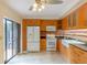 Bright kitchen with wood cabinets, granite countertops, and stainless steel appliances at 707 1St Ct, Palm Harbor, FL 34684