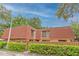Exterior view of condo with red tile roof and wooden fence at 707 1St Ct, Palm Harbor, FL 34684