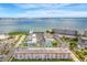 Gorgeous aerial view of waterfront community with buildings, parking, tennis courts, and beautiful water views at 3128 59Th S St # 214, Gulfport, FL 33707
