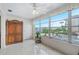 Sunlit bonus room featuring tile floors, large windows offering serene marina views, and classic wooden furniture at 3128 59Th S St # 214, Gulfport, FL 33707