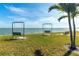 Swings and benches overlooking the water with palm trees on a sunny day, creating a scenic outdoor space at 3128 59Th S St # 214, Gulfport, FL 33707