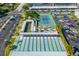 Aerial view of tennis courts, bocce, and shuffleboard in lushly landscaped community at 3128 59Th S St # 214, Gulfport, FL 33707