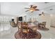 Charming dining area with circular table and chairs, adjacent to a spacious living room with tile flooring at 3128 59Th S St # 214, Gulfport, FL 33707