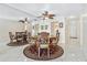 Inviting dining room featuring round table, decorative rug, ceiling fan and reflective mirror wall at 3128 59Th S St # 214, Gulfport, FL 33707