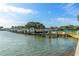 Boat dock with boats in the water, trees and tennis courts in the background on a sunny day at 3128 59Th S St # 214, Gulfport, FL 33707